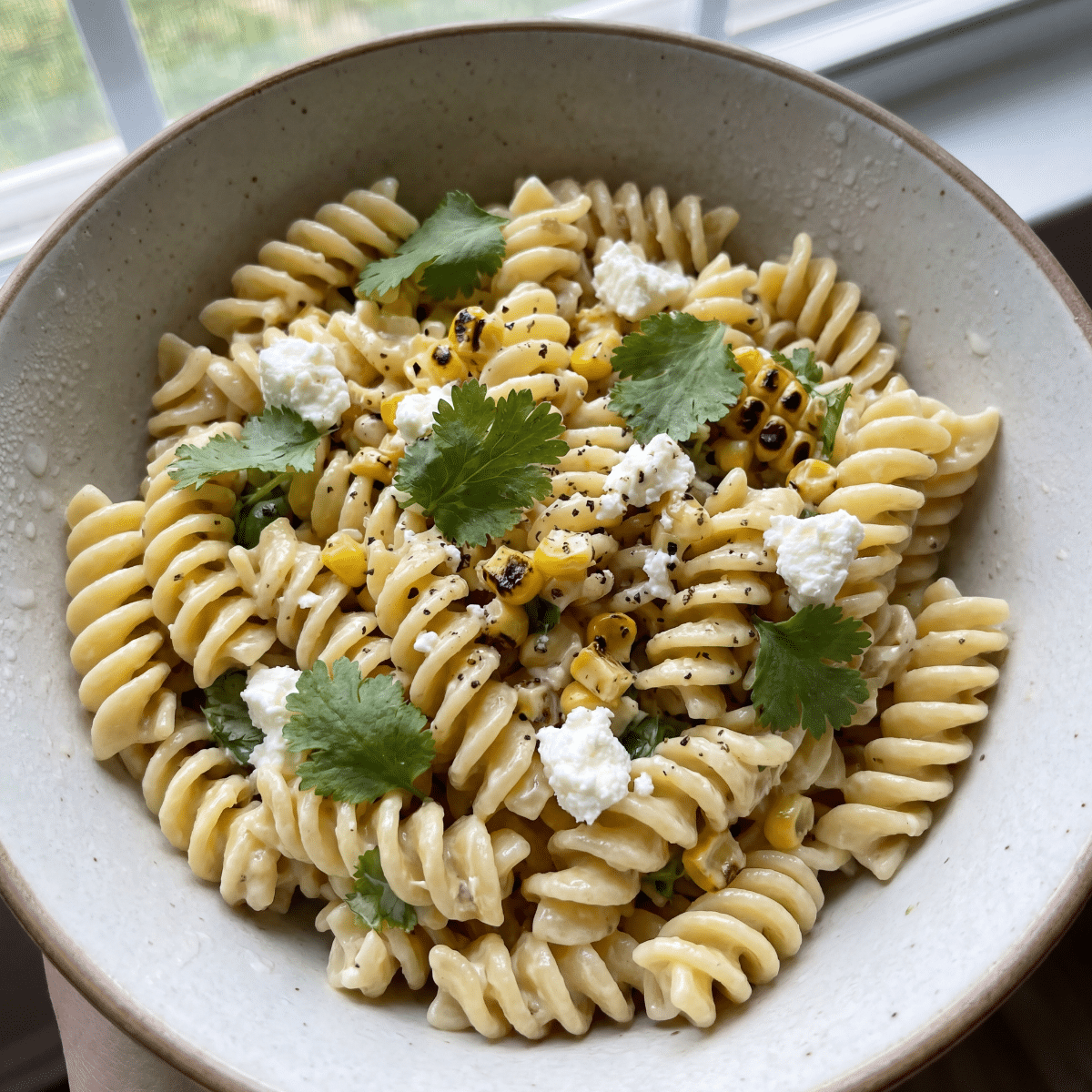 vegetarian pasta salad cold with corn avocado herbs in bowl healthy summer recipe